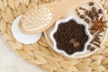 Ground coffee beans for preparing homemade exfoliating spicy scrub and wooden hairbrush. Natural beauty treatment and spa recipe.