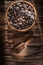 Ground coffee grains bowl scoop on vintage wooden board Royalty Free Stock Photo