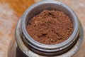 Ground coffee placed in the strainer of a traditional Italian macchinetta (coffee maker).