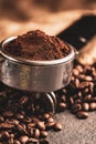 Ground coffee portafilter with coffee beans Royalty Free Stock Photo