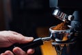 Ground coffee pouring into a portafilter with a grinder Royalty Free Stock Photo