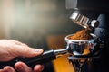 Ground coffee pouring into a portafilter with a grinder Royalty Free Stock Photo