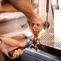 Ground coffee pouring into a portafilter with a grinder Royalty Free Stock Photo