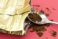 Ground coffee spilled from the packaging. Grinded coffee powder in measuring scoop. Open coffee vacuum foil bag. Royalty Free Stock Photo