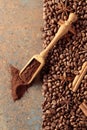 Ground coffee in a spoon and coffee beans with cinnamon and anise on a rusty metal background Royalty Free Stock Photo