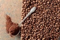 Ground coffee in a spoon and coffee beans on a rusty metal background Royalty Free Stock Photo