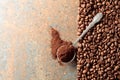 Ground coffee in a spoon and coffee beans on a rusty metal background Royalty Free Stock Photo