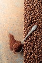 Ground coffee in a spoon and coffee beans on a rusty metal background Royalty Free Stock Photo