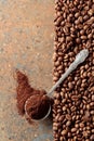 Ground coffee in a spoon and coffee beans on a rusty metal background Royalty Free Stock Photo