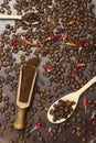 Ground coffee in wooden scoop. Roasted coffee beans in spoon. Roasted coffee beans on table Royalty Free Stock Photo