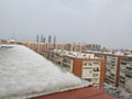 Ground completely snowed in the streets of Madrid with the sky a little open allowing you to see the sun