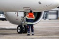 A ground control manager helps to park the aircraft