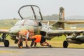 Ground crew examine the underside of a Strikemaster attack aircraft Royalty Free Stock Photo