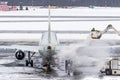Ground crew provides de-icing. They are spraying the aircraft, which prevents the occurrence of frost.