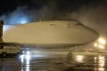 Ground deicing of a big cargo aircraft on the night airport apron