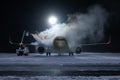 Ground deicing of a passenger aircraft on the night airport apron at winter
