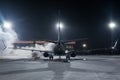 Ground deicing of a passenger airliner on the night airport apron at winter