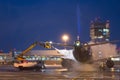 Ground deicing of a passenger airplane on the night airport apron