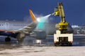 Ground deicing of a passenger airplane on the night airport apron