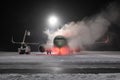 Ground deicing of a passenger airplane on the night airport apron at winter