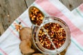 Ground dried chili pepper spilled from glass can and rustic spoon. Top view Royalty Free Stock Photo