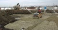 Ground hardening by heavy construction machinery road and factory construction. Loader excavator, bulldozer and roller Royalty Free Stock Photo