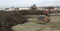 Ground hardening by heavy construction machinery road and factory construction. Loader excavator, bulldozer and roller Royalty Free Stock Photo