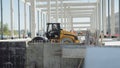 Ground hardening by heavy construction machinery rollers road and factory construction. Loader excavator, bulldozer and