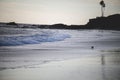 Ground-level scenic shot of foamy waves crashing the shore on the evening, cool for background