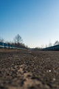 Ground level view down an empty asphalt bridge with blue guardrails Royalty Free Stock Photo