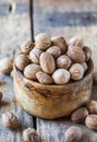Ground nutmeg in  bowl and whole nuts on an old wooden background Royalty Free Stock Photo