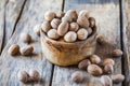 Ground nutmeg in  bowl and whole nuts on an old wooden background Royalty Free Stock Photo