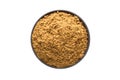 Ground nutmeg powder in clay bowl isolated on white background.
