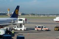 ground operation with ambulance car and movable ambulance container loading to a Lufthansa jet