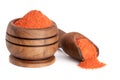 Ground paprika in a wooden bowl with a scoop isolated on a white background Royalty Free Stock Photo