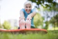 Senior woman doing yoga and legs stretching in the park Royalty Free Stock Photo