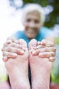 Senior woman doing yoga and legs stretching in the park Royalty Free Stock Photo