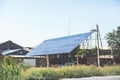 Ground and pole mounted residential solar panel, renewable energy system installed in the vegetable garden near the house.