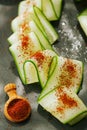 Ground Red Sumac Berries sprinkled on cucumber slice Royalty Free Stock Photo