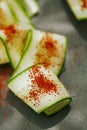 Ground Red Sumac Berries sprinkled on cucumber slice Royalty Free Stock Photo