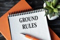 GROUND RULES - words in white notebook on dark wooden background with cactus and pen Royalty Free Stock Photo