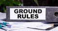 GROUND RULES is written on a gray file folder next to documents. Business concept Royalty Free Stock Photo