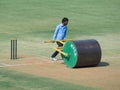 Ground`s men Levelling cricket pitch. Royalty Free Stock Photo