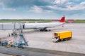 Ground service truck at the airport near an airline plane parked near the Gates. Delivery of food and drinks on board Royalty Free Stock Photo