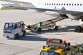 ground staff handling an aircraft before departure at the airport - loading luggage