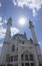 Ground view of big kazan kremlin with rounded sun and cloudy blue sky