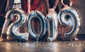 Ground view. Group of friends with inflatable numbers in hands celebrating new 2019 year Royalty Free Stock Photo