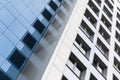 Ground view of tall modern building facade, blue and white smooth facade surface. Royalty Free Stock Photo