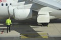 Ground Worker Checking the Plane