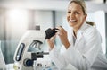 This is groundbreaking. Cropped portrait of an attractive mature female scientist using a microscope while doing
